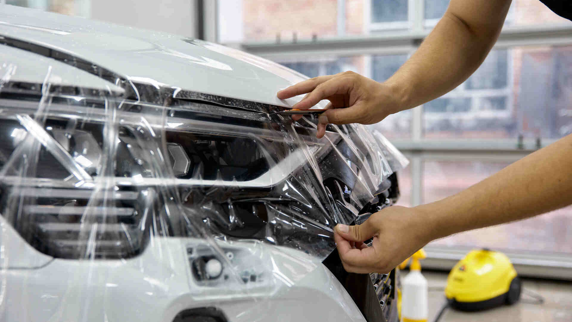 Paint protection film being applied to a car in New Jersey